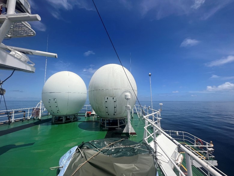 Two VSAT radomes on the deck of a vessel at sea